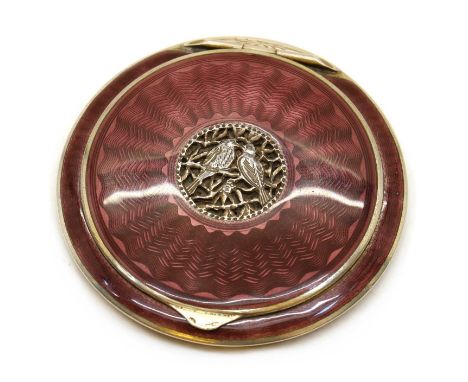 An enamelled silver compact,1930s, likely Austrian, of disc shape, throughout with purple guilloche enamel over a variety of 