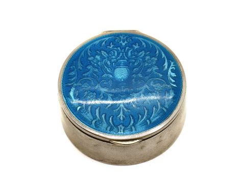 An enamelled silver pill box,with Glasgow import marks 1923, of circular form, the lid with electric blue guilloche enamel ov