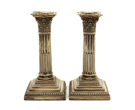 A pair of late Victorian silver candlesticks,by Goldsmiths and Silversmiths Company, London 1900, modelled as Corinthian colu