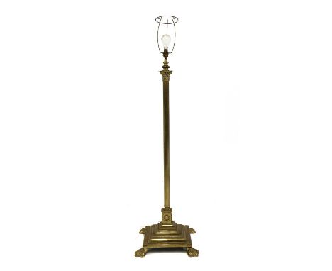 A Corinthian column standard lamp,20th century, on stepped square section base, terminating in brass paw feet, 125cm to fitti