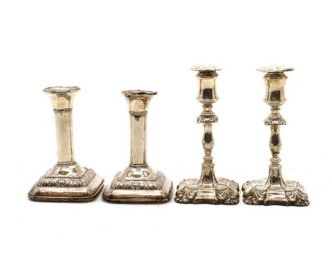A pair of Victorian silver candlesticks,by Jane Brownett, London 1889, the foliate knopped stem leading to square loaded base