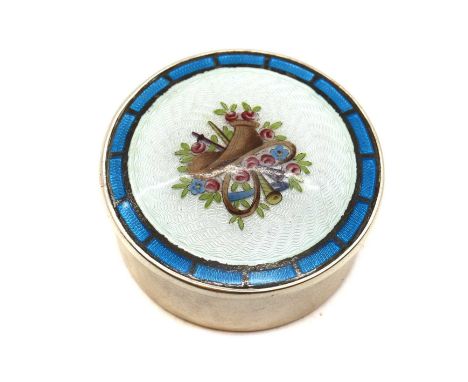 An Edwardian enamelled silver pill box,by Levi &amp; Salaman, Birmingham 1909, of round form, the pull of lid of slightly con