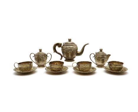 An Indian silver tea service,early 20th century, comprising a teapot, 16cm high, a cream jug, 12.5cm high, a twin-handled sug