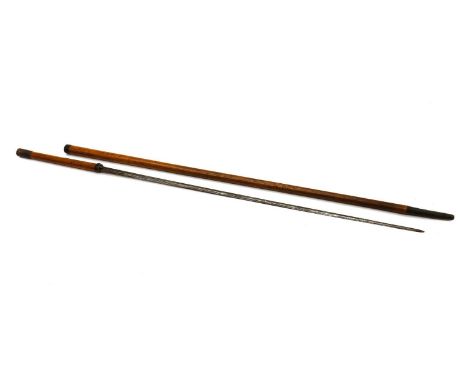 A sword stick cane,early 20th century, with a triangular blade, the cane with brass mounts etched with floral swags, 117cm hi