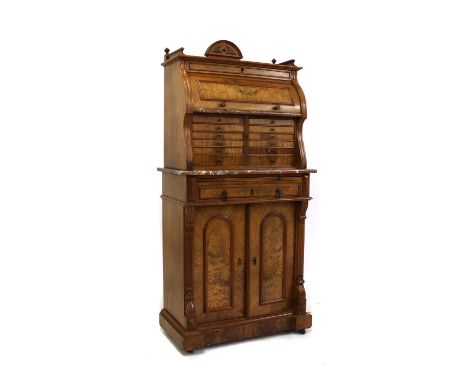 A German walnut dentist's or collector's cabinet,late 19th century, the top with a configuration of drawers and a cylinder co