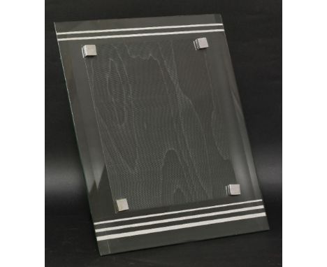 An Art Deco photograph frame,by Asprey London, the bevelled edge with silvered lines, with square chrome nuts, and an easel b