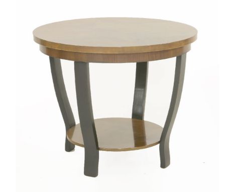 An Art Deco walnut lamp table,the circular top raised on ebonised short supports with an undertier,61cm diameter50cm high