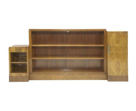 A French burr walnut bookcase,the central inverted open bookcase with two adjustable shelves, flanked with a cupboard and a d