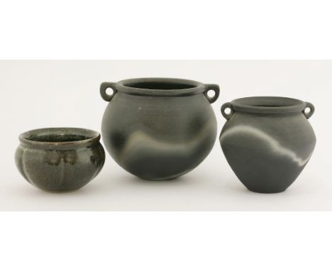*Three Mulchelney pottery vessels, by John Leach (b.1939), two smoked cauldron pots and a glazed pot, impressed seal marks (3