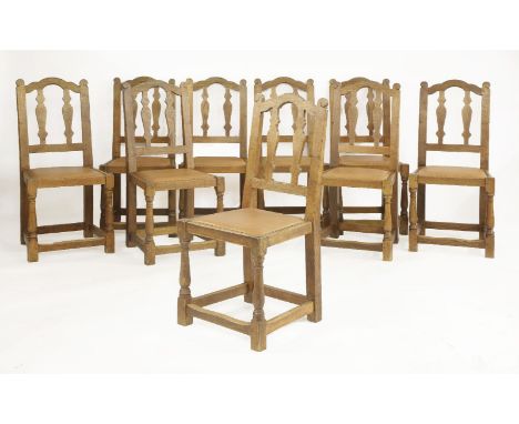 A set of ten rare Robert 'Mouseman' Thompson dining chairs,with fret cut splat backs, tan leather pads on solid seats, one ca