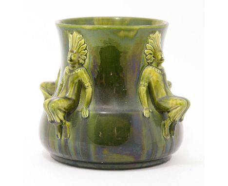 An Ault green and yellow mottled glaze jardinière, designed by Dr Christopher Dresser, the four handles modelled as Native Am