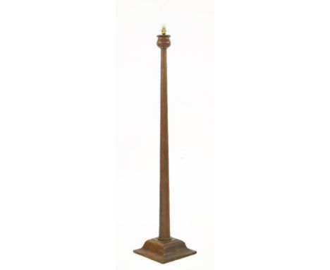 An Arts & Crafts oak standard lamp, possibly designed by Ambrose Heal, with a contemporary shade, 145cm high
