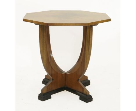 An Art Deco walnut lamp table,the octagonal top with quarter veneered top, raised on a shaped 'X' frame stand and on ebonised