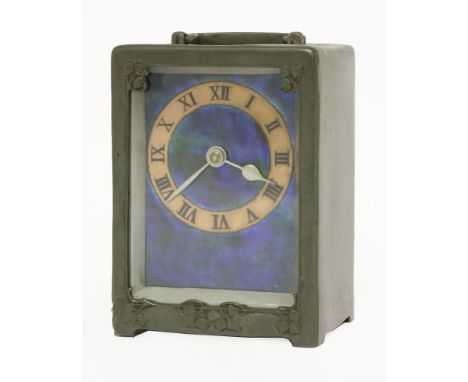 A Tudric pewter and enamel desk clock, designed by Archibald Knox for Liberty & Co., the front with ivy details and with a sw