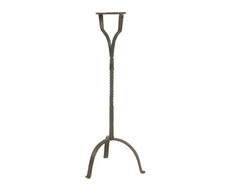 An Arts and Crafts iron torchère,with a turned central column, on a tripod stand,120,5cm high