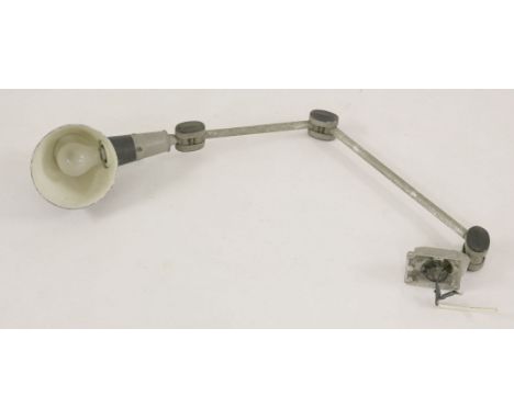 An industrial wall-mounted light,with a painted shade and integral switch to wall bracket