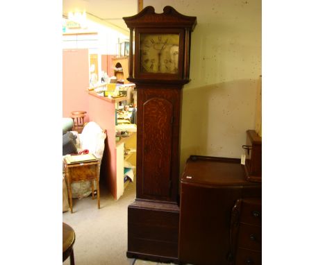 An early 19th Century oak 30 day longcase clock, the 11" painted enamel dial with Roman numerals, minute track and spandrels 