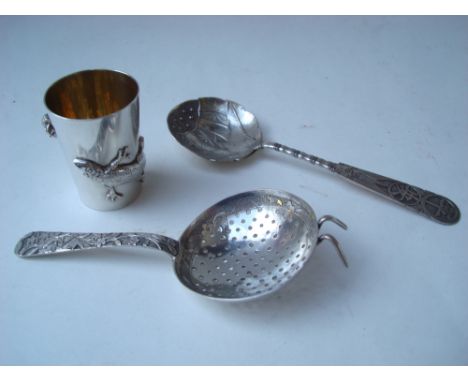 An early 20th Century Chinese silver spirit measure by Wang Hing, the exterior with a lizard and spider cast in relief, 4.5cm