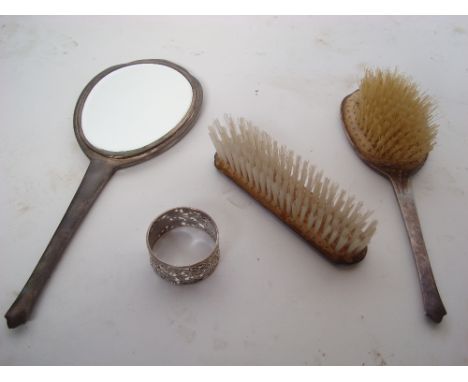 A three piece engine turned silver dressing table set, Birmingham, 1963 and a silver napkin ring (4). 