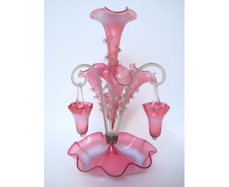 A Victorian cranberry vaseline glass epergne, the central trumpet with wavy edged rim, the stem with pinched clear glass trai