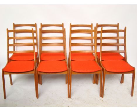 A set of eight mid 20th Century Danish Korup Stolefabrik teak ladder back dining chairs, with padded seats covered in red fab