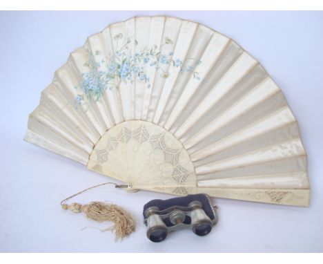 An early 20th Century French silk fan, printed with flowers with pierced and carved bone sticks with silk tassel together wit
