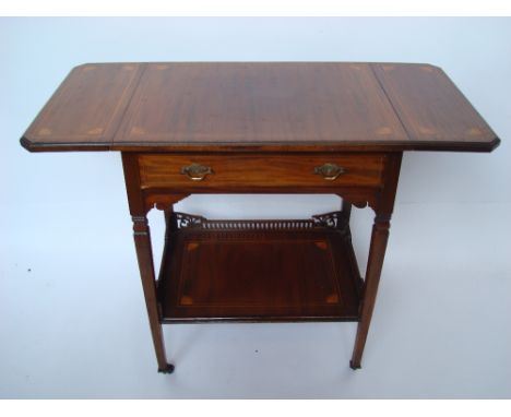 An Edwardian mahogany side table, the top with twin flaps, satinwood strung and inlaid with fan patterae to corners over a fr