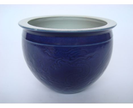 Chinese blue ground porcelain jardiniere, sgraffito decorated with a pair of dragons chasing the flaming pearl, 20cm high. 