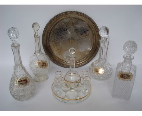 Three cut glass and crystal claret jugs and stoppers, a square whiskey decanter, each with an EPNS label, a liqueur set with 