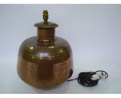 A large Indian hardwood brass and copper vessel fitted as a table lamp. 