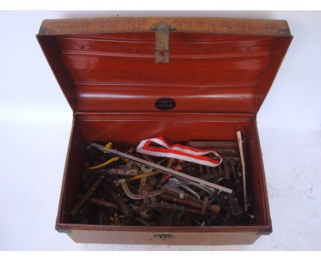 An early 20th Century painted steel trunk containing a selection of tools. 