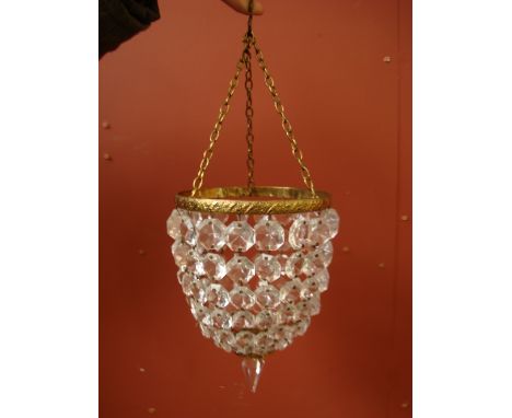 An early 20th century small basket ceiling light, the foliate  cast gilt brass girdle suspended on chains and hung with taper