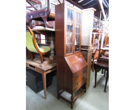 A small early 20th century oak bureau bookcase, the upper section enclosed by a pair of rectangular leaded light glazed panel