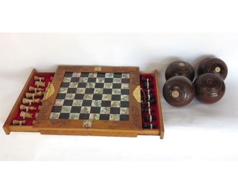 Vintage folding travelling games board with chess pieces together with four hard wood lawn bowls