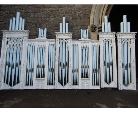 A chapel organ facade (upper section) in pine and in a Gothic style with faux pipe work with carved and pierced, painted fini