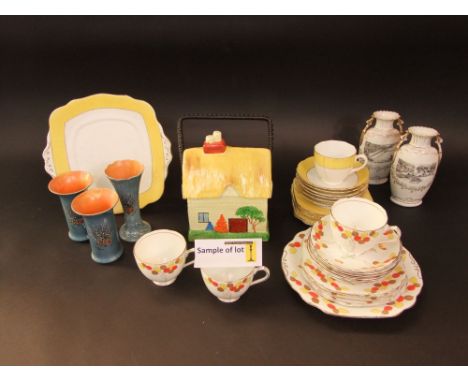 A collection of ceramics including a cottage ware biscuit barrel and cover in the form of a thatched cottage, an Art Deco dia
