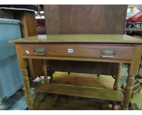 A satin walnut side table with frieze drawer on turned supports and under shelf, 90 cm