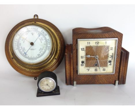 Brass and oak bulkhead wall barometer together with a further three train vintage mantle clock and small Bakelite clock (3)