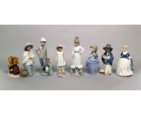 A collection of Nao figures including a girl wearing a wide brimmed hat and holding a chicken, further girl in hat, three chi