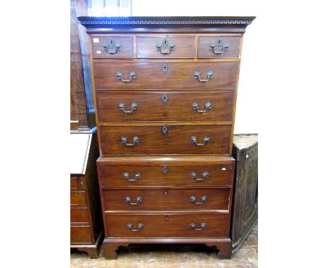 A Georgian mahogany and oak lined chest on chest enclosing an arrangement of three long and three short graduated drawers wit