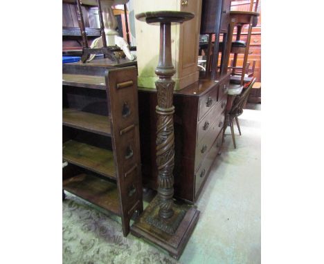 A mahogany torchere, the column with carved acanthus, ring turnings and gadrooned detail, raised on a stepped square platform