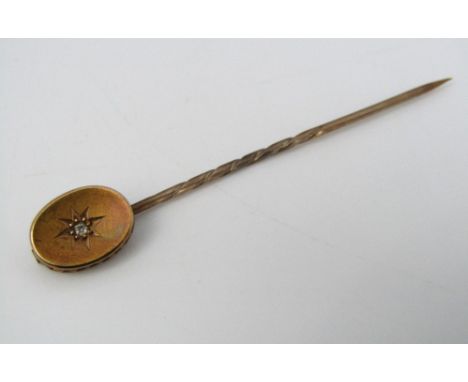 A Victorian 15ct stick pin with pierced gallery, set with a single diamond