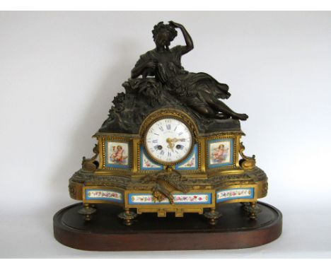 Good French figural mantle clock, mounted by a recumbent lady with flowers, the 4 inch two train enamelled dial with Roman an