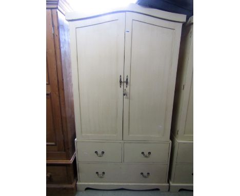 A contemporary painted wardrobe the upper section enclosed by two panelled doors over an arrangement of one long and two shor