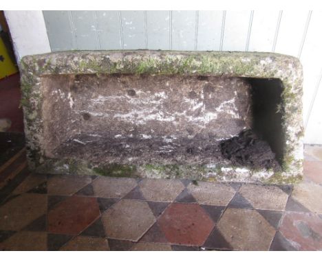 A weathered garden trough of rectangular form with canted/angular ends 100 cm long x 44 cm wide x 26 cm deep approx