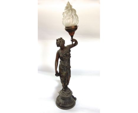 French bronzed spelter figural table lamp of a robed female holding a torch, glass shade, 94 cm high total