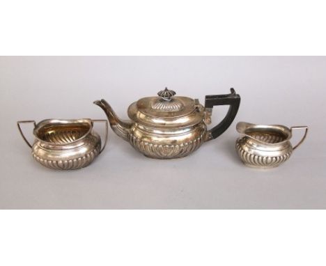 Edwardian three piece silver tea service comprising silver tea pot, milk jug and twin handled sucrier, with half gadrooned de