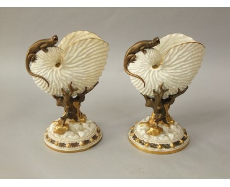 A pair of 19th century Royal Worcester vases modelled as nautilus shells supported by coral and shells and with applied lizar