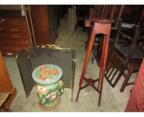 A ceramic garden seat in the Chinese manner supported by three elephants together with an Edwardian mahogany plant/torchere s