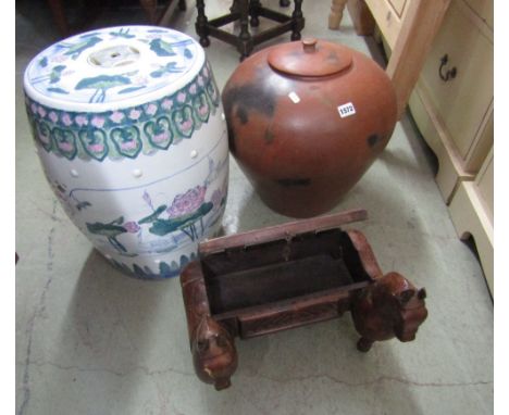 A Chinese ceramic barrel shaped garden seat with lily, dragonfly and other detail, a further terracotta oviform pot and cover